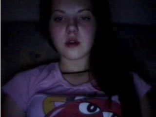 Amateur bruntte teen licks her lips in front of a webcam