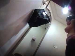 Hidden camera filming sexy curvy MILF in changing room