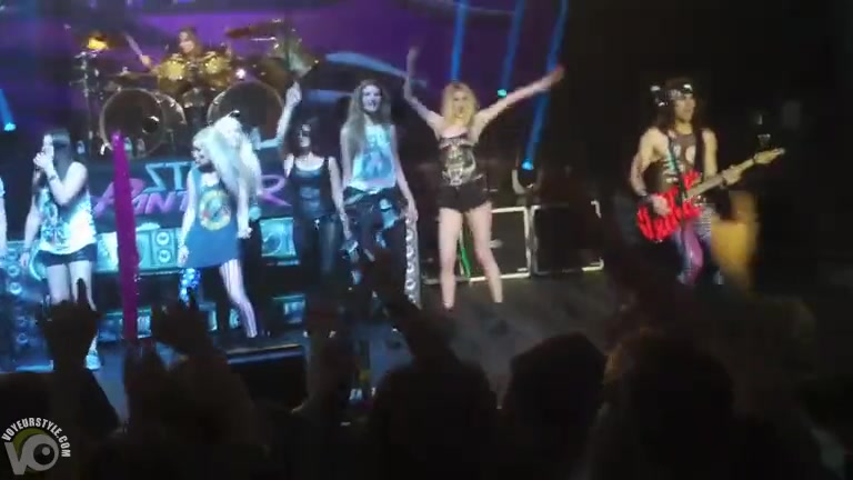 Attractive fan girl goes topless on the stage