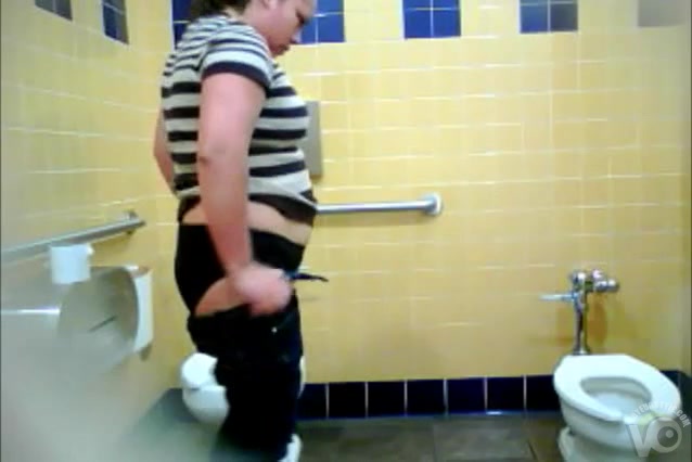 Chubby woman takes a leak in a public WC