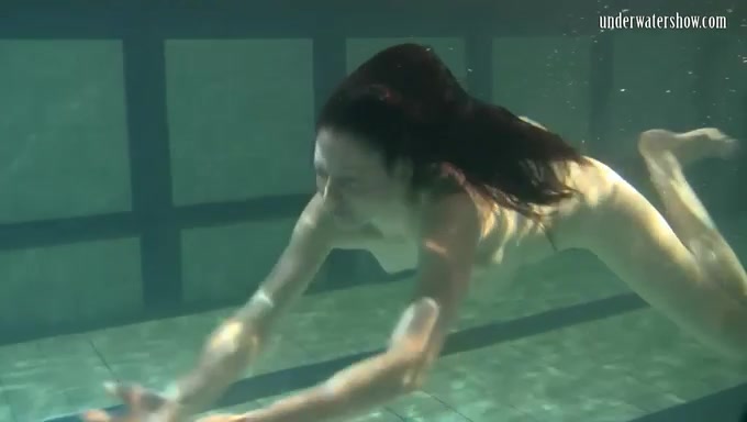 Adorable brunette Russian teen underwater in her dress