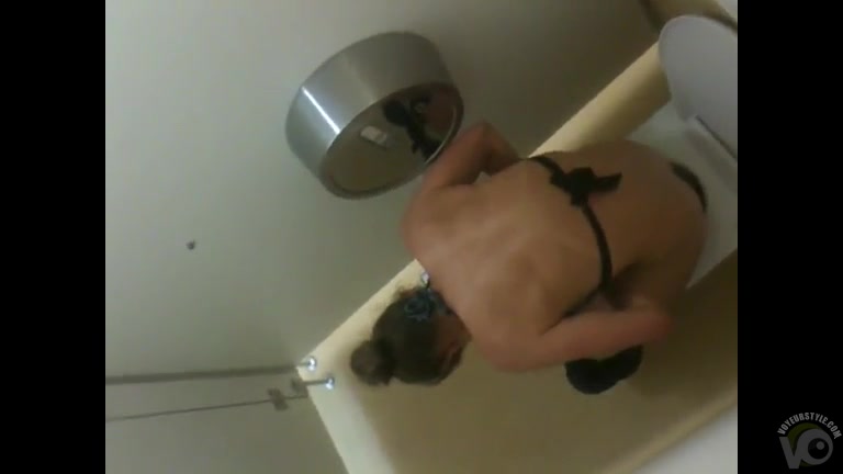 Urinating bikini girl filmed over the restroom wall