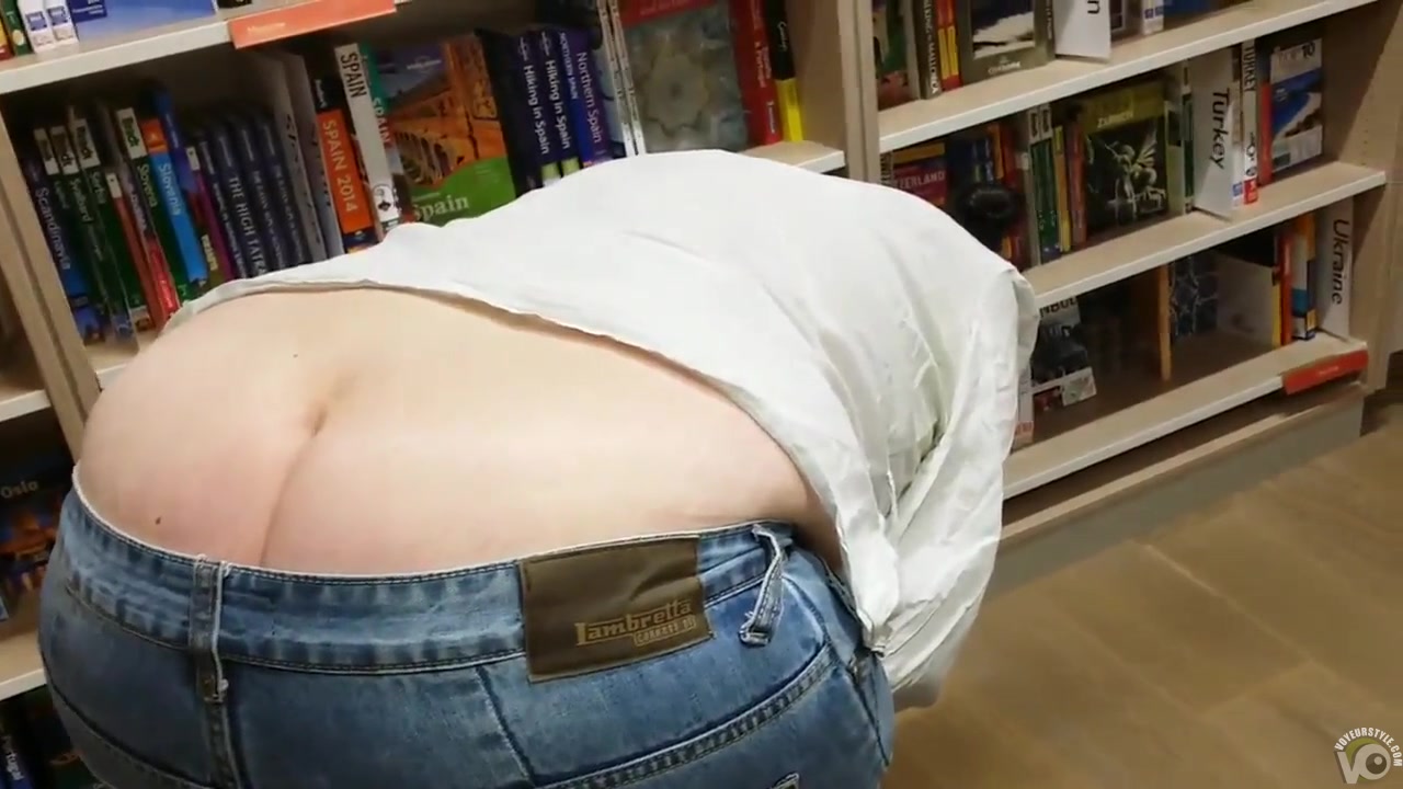 Chick's butt pops out when she bends over to pick up a book