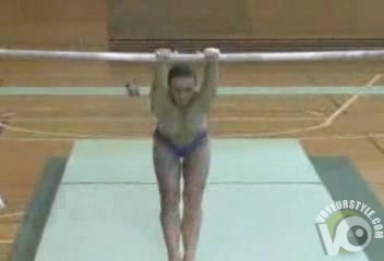 Gymnast does the uneven bars topless