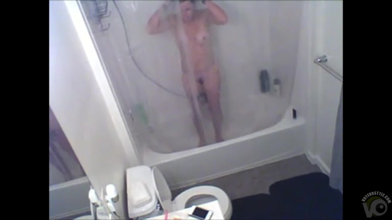 Short-haired babe is recorded while showering