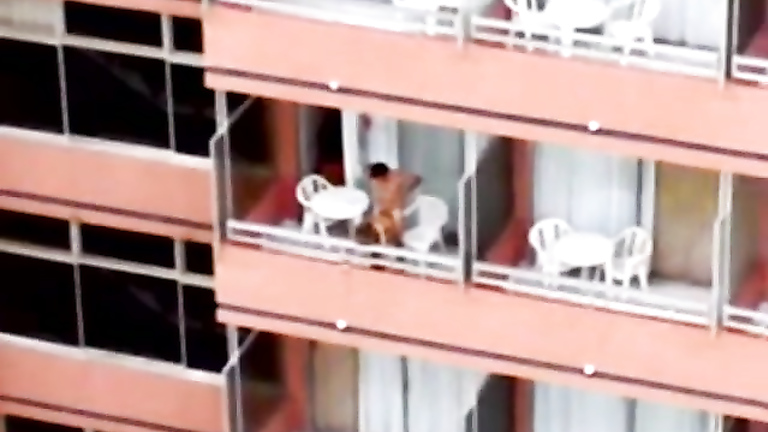 Exhibitionist girl gets her hungry pussy plugged hard on the balcony