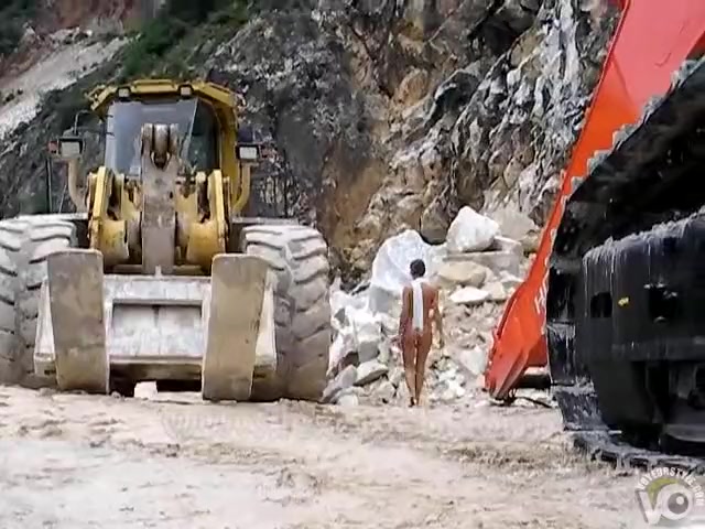 Naked lady in high heels walks the construction site