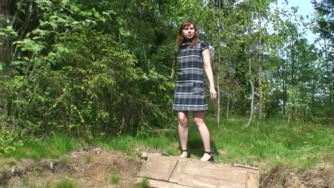 Redhead Russian amateur girl in the forest squats and pisses