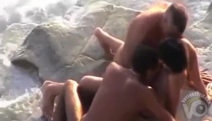 Ocean waves crash during outdoor threesome