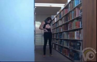 Funny babe in a tank top flashes tits in the library