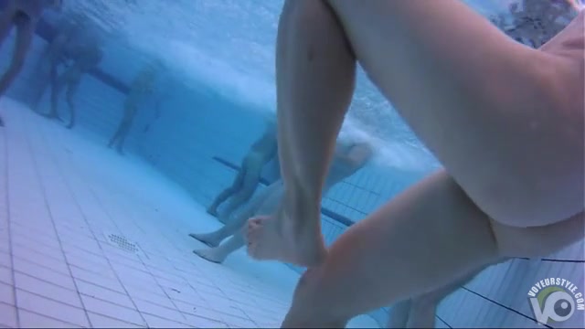 Naked men and women in the pool filmed underwater