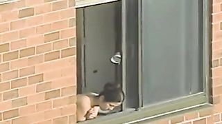 Topless woman looks out her window--_short_preview.mp4