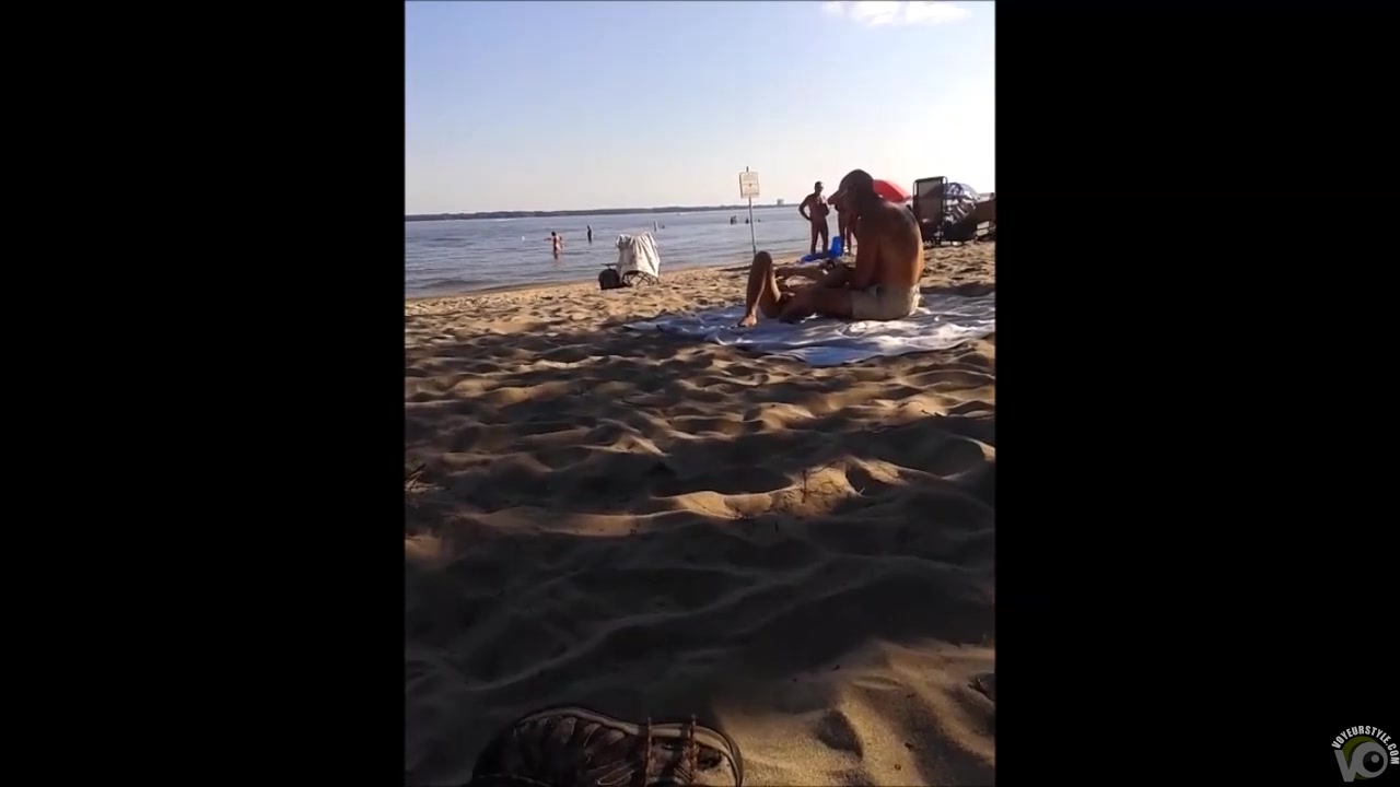 Seductive nudist girlfriend has her pussy exposed on the middle of the beach