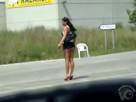 Shameless girl walks down the street in a micro skirt