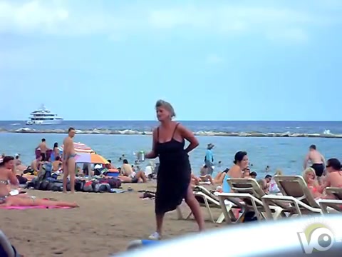 Crazy woman decides to piss on the beach sand