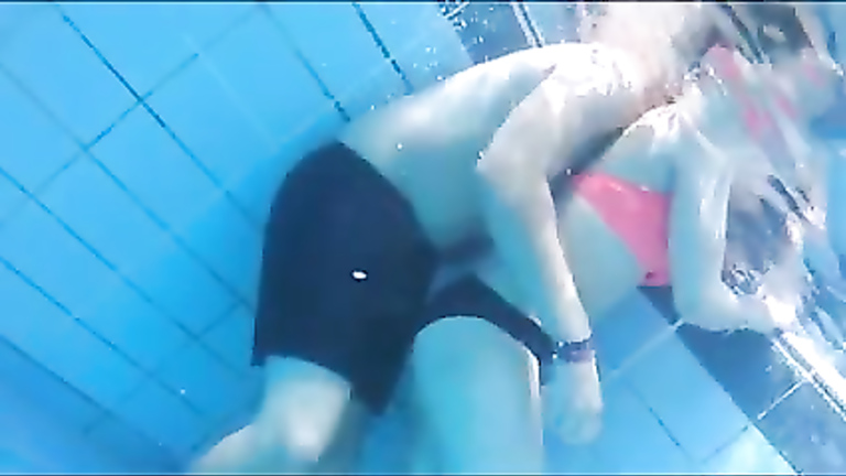 Playgirl tugs on a friend's dick in the pool
