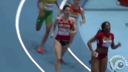 Athletic woman runs around the track in a flimsy outfit
