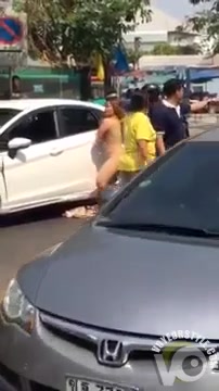 Crazy woman exposes her naked body on the road