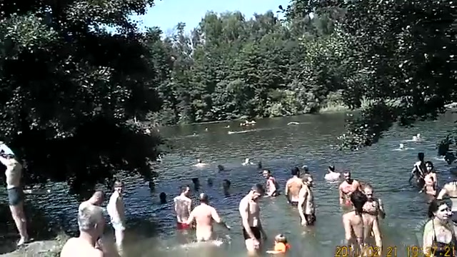 Nudist camp at the lake with lots of men and women