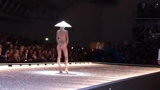 Seductive fashion model in a weird hat walks down the catwalk in the nude--_short_preview.mp4