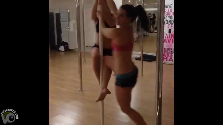 Girls at stripper fitness class spin on the pole