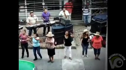 Topless Latin American ladies dancing in the streets