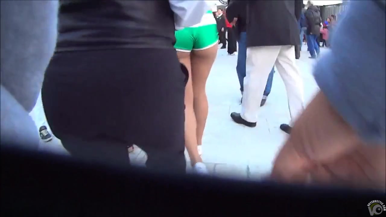 Cute model in a miniskirt mingles with people while being filmed