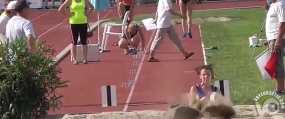 Athletic girl runs around the track in tight clothes