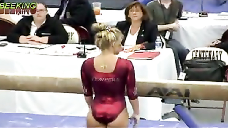 Female gymnast with a powerful ass in a shiny leotard