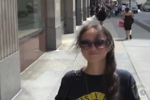 Beautiful girl on the street flirts with a smile