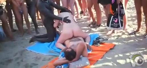Beach girl rides dick and sucks another for a crowd
