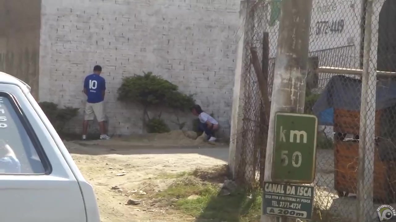 Soccer player uses his body to hide his pissing girlfriend