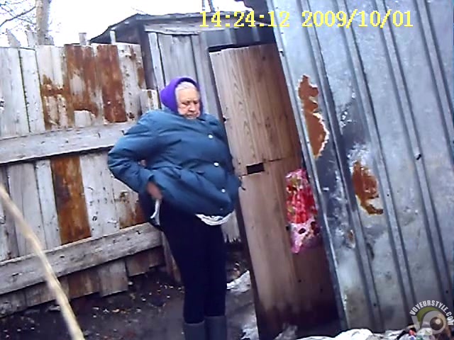 Old Russian woman takes a liquid shit outdoors