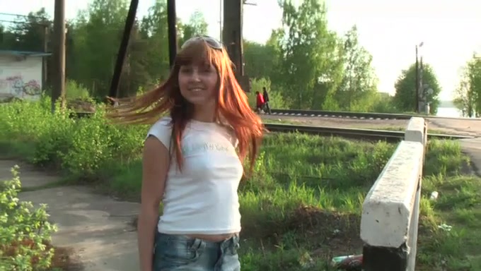 Really hot and lascivious redhead teen shows her breasts by the railway