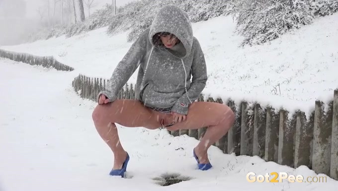 Freaky bitch walking in the blizzard pees on the snow