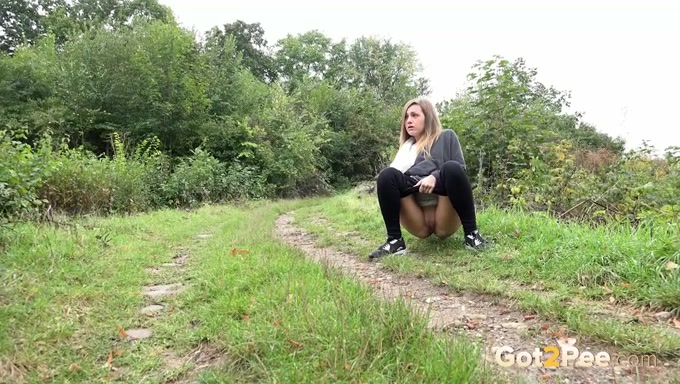 Nervous chick doesn't want to be caught while pissing outdoors