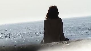 Naked girl caught sitting on the sandy beach all alone--_short_preview.mp4