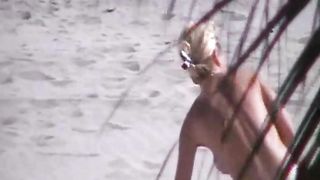 Spying on one busty blonde babe taking a sunbath on beach topless--_short_preview.mp4