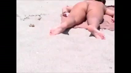 Amateur brunette gets caught on a hidden cam on a beach