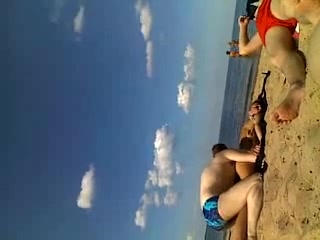 Friend gives his sassy girlfriend massage on the beach