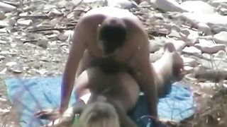 Auburn pallid chick lies on her belly while being poked on cobble-stone beach--_short_preview.mp4
