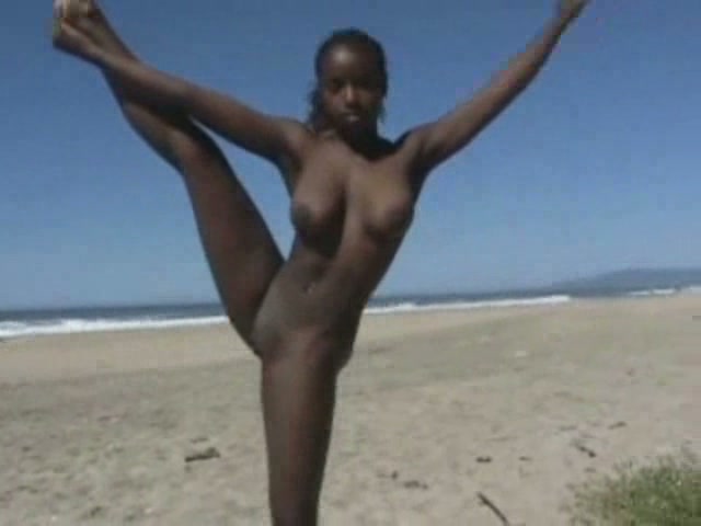 Busty ebony amateur hottie on the beach doing acrobatic tricks